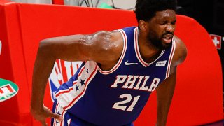 Joel Embiid holds his back