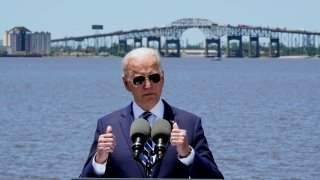 President Joe Biden speaks with the Interstate 10 Calcasieu River Bridge behind him, Thursday, May 6, 2021, in Lake Charles, La.
