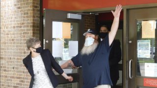 Gilbert Poole Jr., right, accompanied by attorney Marla Mitchell-Cichon, leaves prison in Jackson, Mich., Wednesday, May 26, 2021, after being exonerated of first-degree murder in Oakland County. Poole spent 32 years in prison. Authorities said he was wrongly convicted with unreliable evidence.