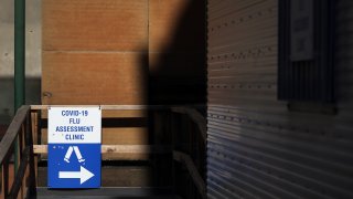 A sign directing people to a Covid-19 Flu Assessment Clinic in the central business district in Sydney, Australia, on Friday, April 30, 2021.