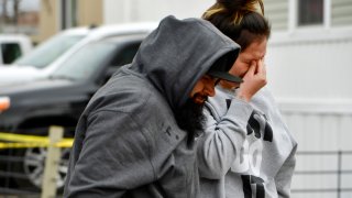 COLORADO SPRINGS, COLORADO - MAY 9: Freddy Marquez, left, walks walks his wife Nubia whose mother was one of six shooting victims, away from the scene of the shooting at the Canterbury Mobile Home Park on May 9, 2021 in Colorado Springs, Colorado. A gunman killed six people at a family birthday party before taking own life, police said. The victims were all members of the same extended family a party attendee said. The shooting was in the 2800 block of Preakness Way in the Canterbury Mobile Home Park. The shooting happened just after midnight. Colorado Springs police Lt. James Sokolik said in a news release. Investigators believe the shooter, who has not been publicly identified, was the boyfriend of a woman at the party.