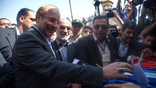 In this file photo, Iran’s parliament speaker Mohammad Bagher Qalibaf (L) casts his ballot at a polling station during the first round of the presidential election on June 14, 2013 in Tehran, Iran.