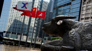 The Chinese and Hong Kong flags flutter outside the Exchange Square complex in Hong Kong on Feb. 16, 2021.