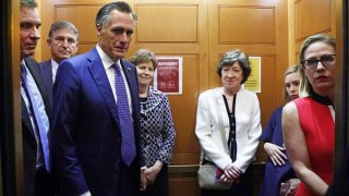 (L-R) U.S. Sens. Mark Warner (D-VA), Joe Manchin (D-WV), Mitt Romney (R-UT), Jeanne Shaheen (D-NH), Susan Collins (R-ME) and Kyrsten Sinema (D-AZ) take a break from a meeting on infrastructure for going to a vote at the U.S. Capitol June 8, 2021 in Washington, DC.