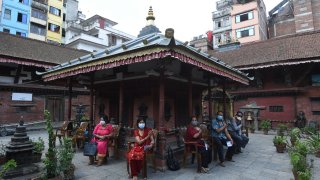 People wait after receiving a dose of Chinese-made Vero Cell Covid-19 vaccine in Kathmandu on June 8, 2021.