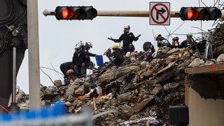Team of rescue workers are seen during a rescue operation of Champlain Tower partially collapsed in Surfside, Florida, United States on June 30, 2021.