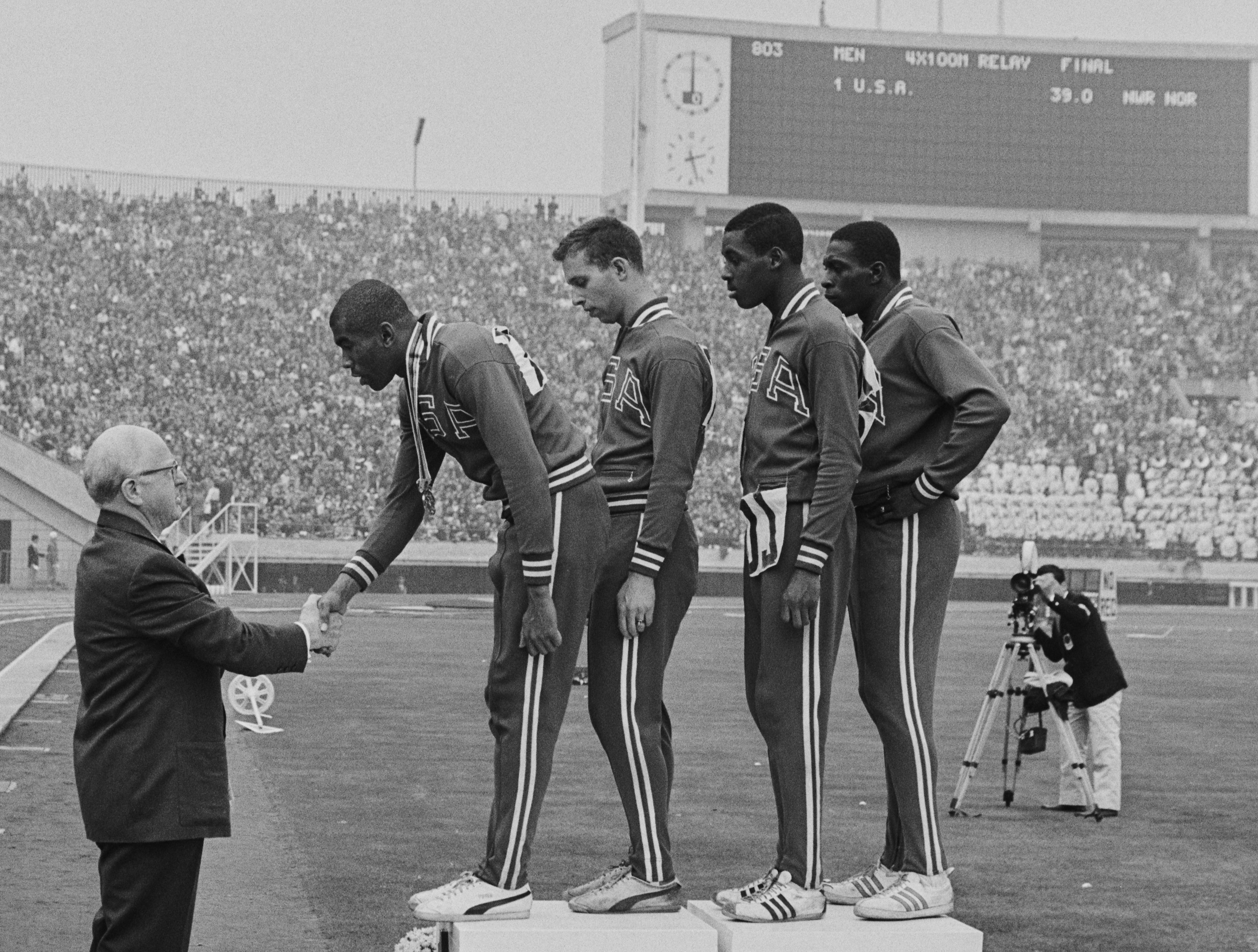 Avery Brundage, President of the International Olympic Committee, presents the winning gold medals to Otis Paul Drayton, Gerald Ashworth, Richard Stebbins and Robert Hayes of the United States during the medal ceremony for winning the Men’s 4 x 100 meters relay competition on Oct. 21, 1964, during the Summer Olympic Games in Tokyo, Japan.