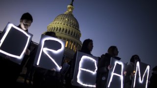 Demonstrators hold illuminated signs during a rally supporting the Deferred Action for Childhood Arrivals program (DACA), or the Dream Act, outside the U.S. Capitol building in Washington, D.C., Jan. 18, 2018.