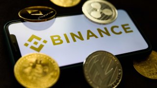 The logo of cryptocurrency exchange Binance displayed on a phone screen.