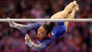 Suni Lee competes on the uneven bars