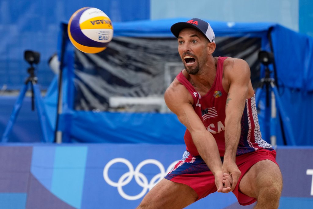 Nicholas Lucena, of the United States, returns a shot during a men's beach volleyball match against Brazil at the 2020 Summer Olympics, Tuesday, July 27, 2021, in Tokyo, Japan.