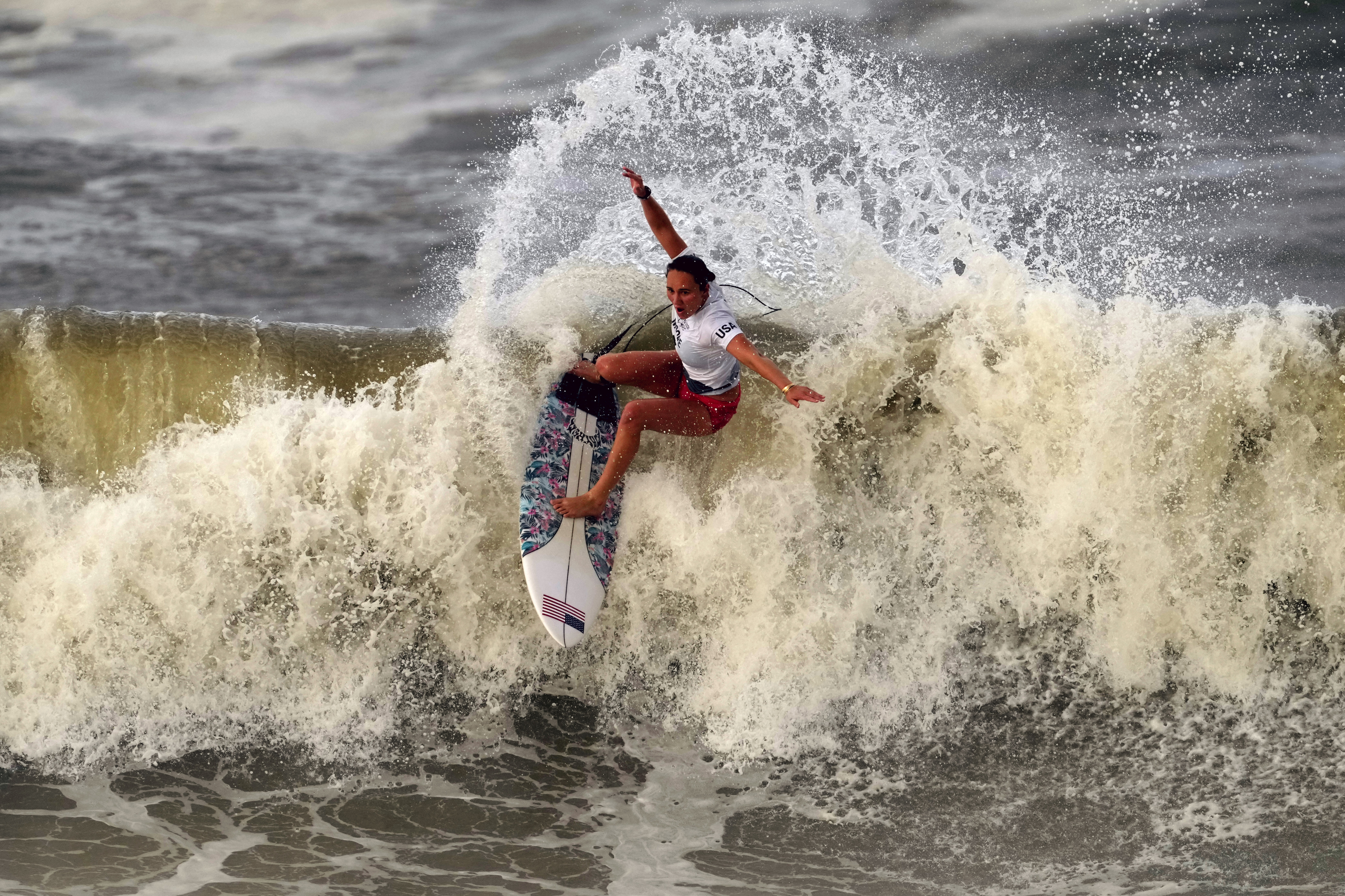 Carissa Moore, of the United States, preforms on the wave during the gold medal heat in the women's surfing competition at the 2020 Summer Olympics, Tuesday, July 27, 2021, at Tsurigasaki beach in Ichinomiya, Japan.