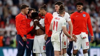 England players comfort teammate Bukayo Saka