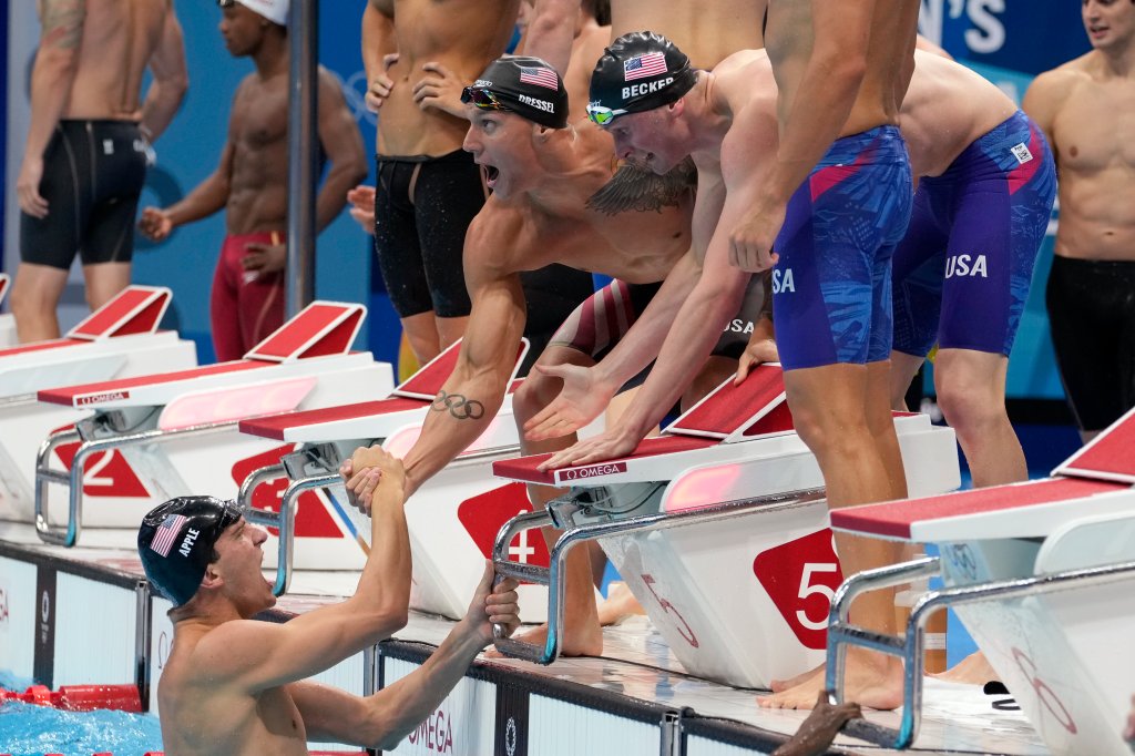 United States men's 4x100m freestyle relay team celebrate after winning the gold medal at the 2020 Summer Olympics, Monday, July 26, 2021, in Tokyo, Japan.