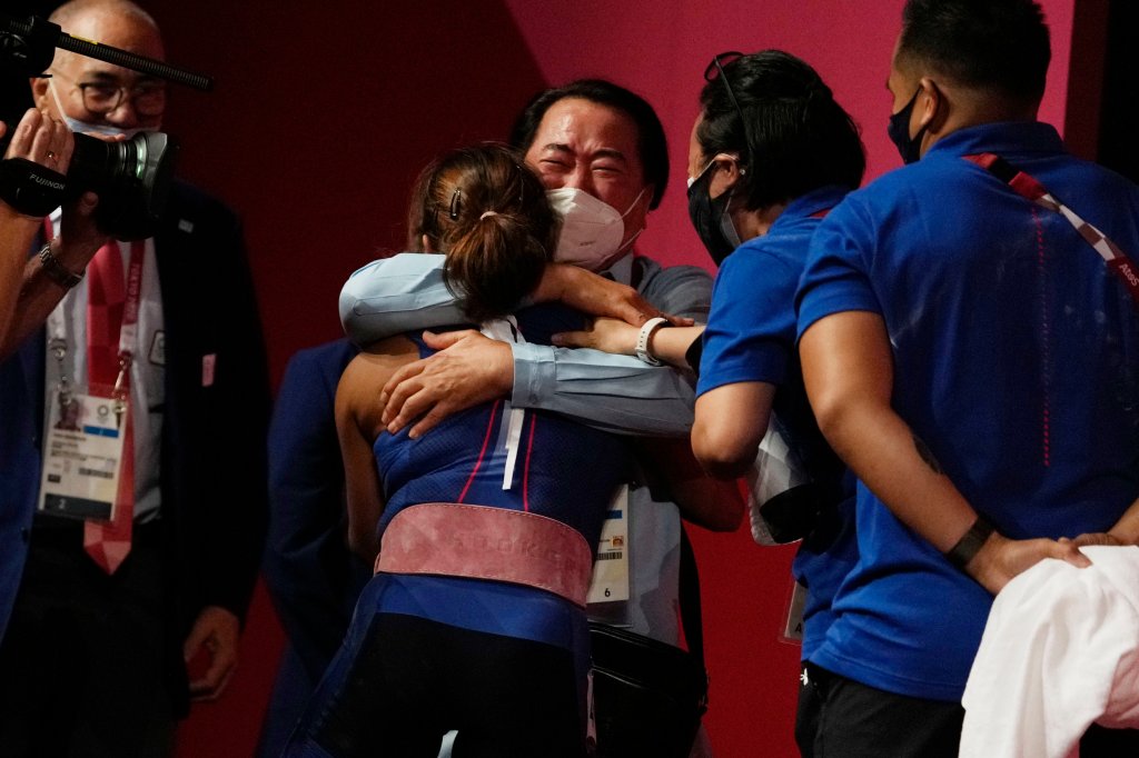 Hidilyn Diaz of Philippines celebrates with Weightlifting Philippines federation president Monico Puntuevella after winning the gold medal in the women's 55kg weightlifting event, at the 2020 Summer Olympics on July 26, 2021, in Tokyo, Japan.