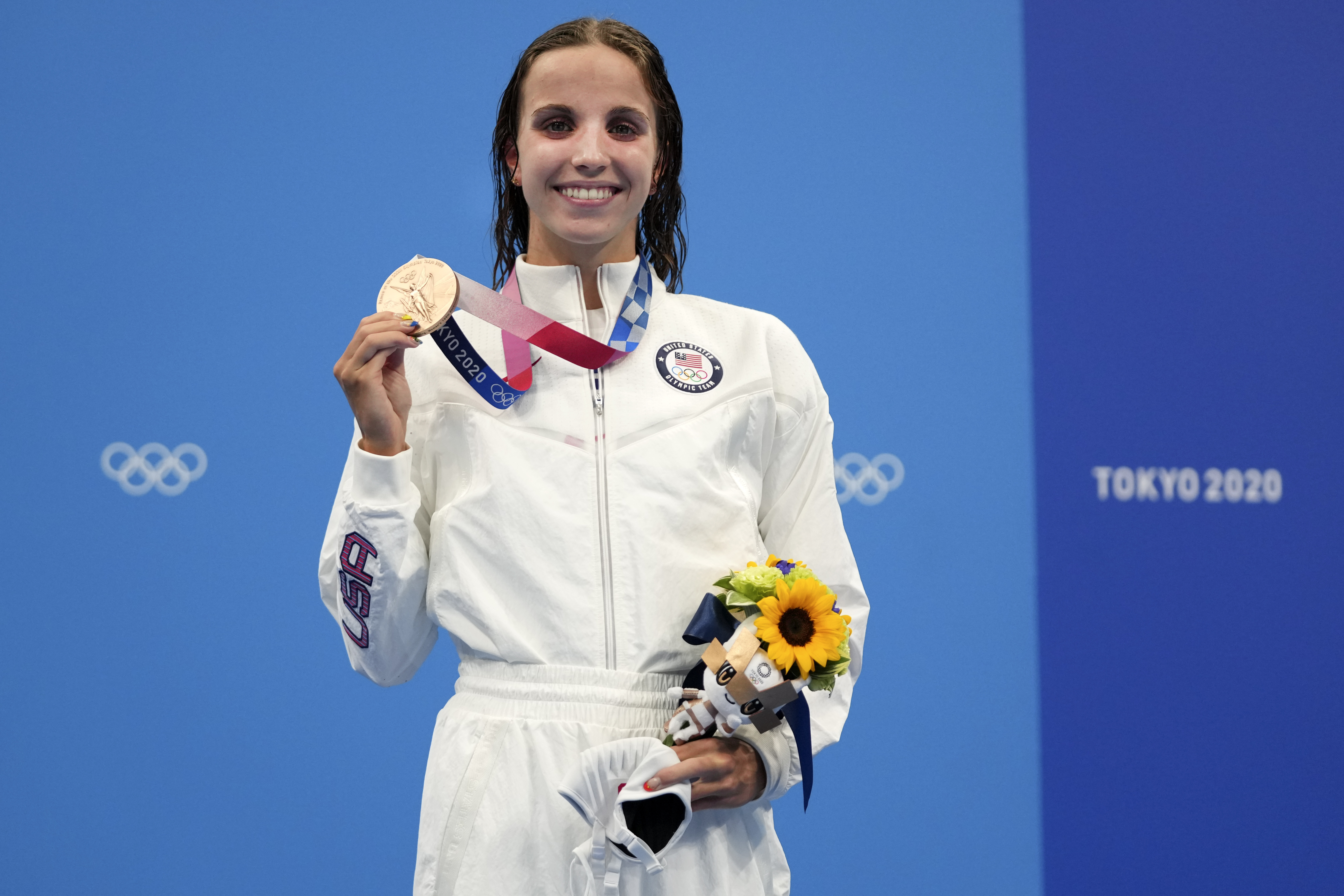 Regan Smith of the United States holds up her bronze medal for the women's 100-meter backstroke at the 2020 Olympics on July 27, 2021, in Tokyo, Japan.