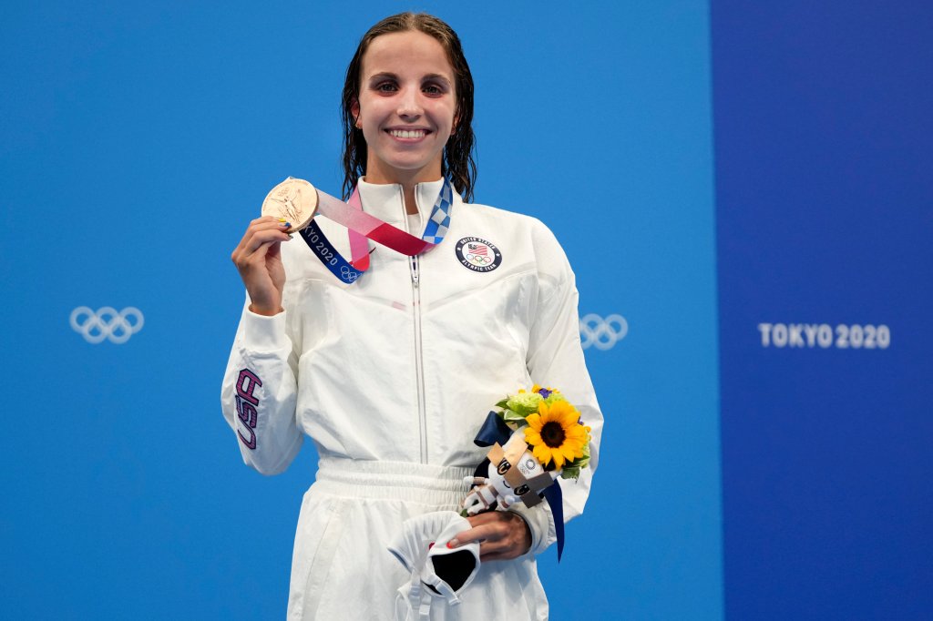 Regan Smith of the United States holds up her bronze medal for the women's 100-meter backstroke at the 2020 Olympics on July 27, 2021, in Tokyo, Japan.