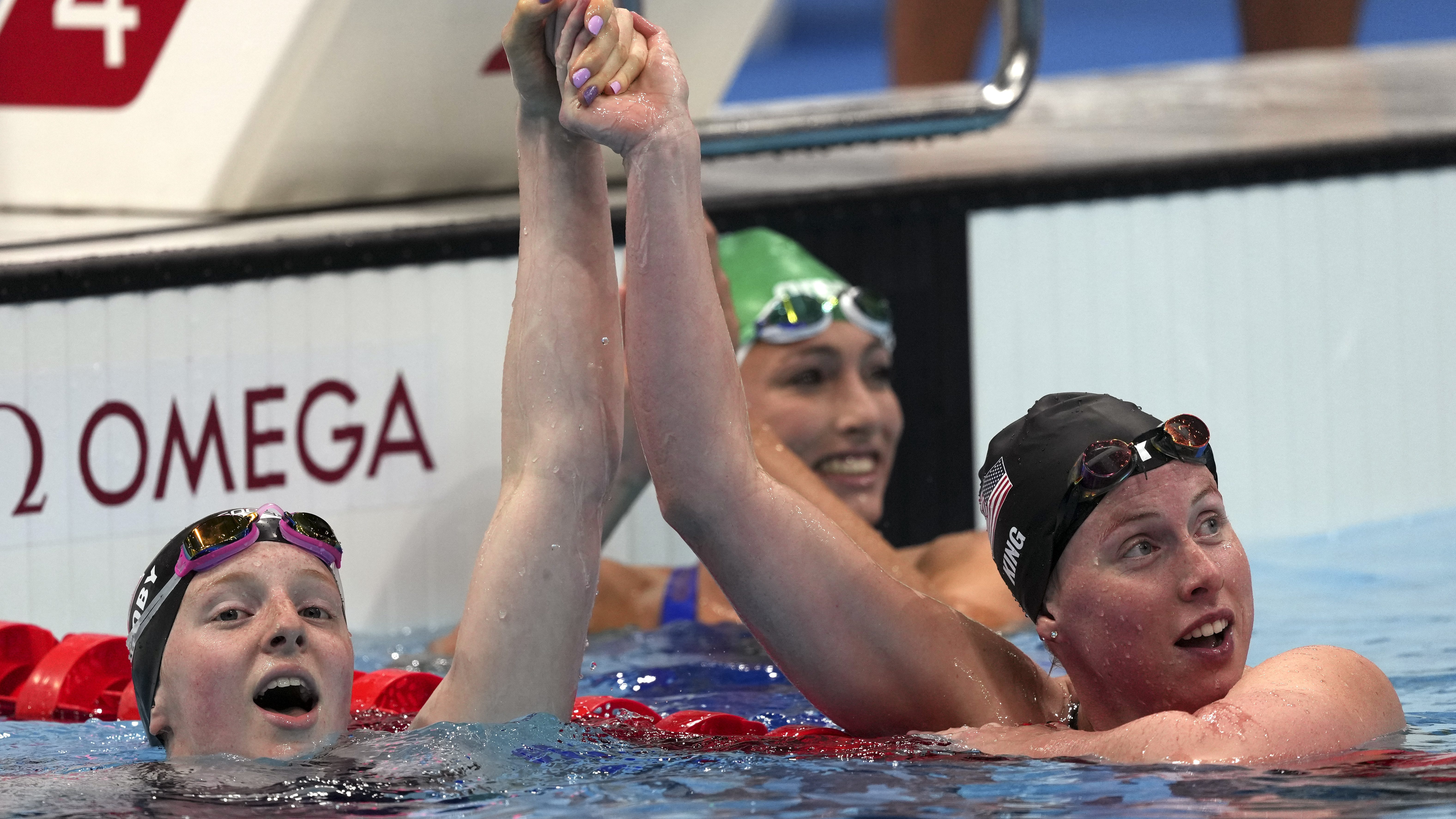 Gold medalist Lydia Jacoby, left, of the United States, is congratulated by bronze medalist and compatriot Lilly King after winning the final of the women's 100-meter breaststroke at the 2020 Summer Olympics, Tuesday, July 27, 2021, in Tokyo, Japan.