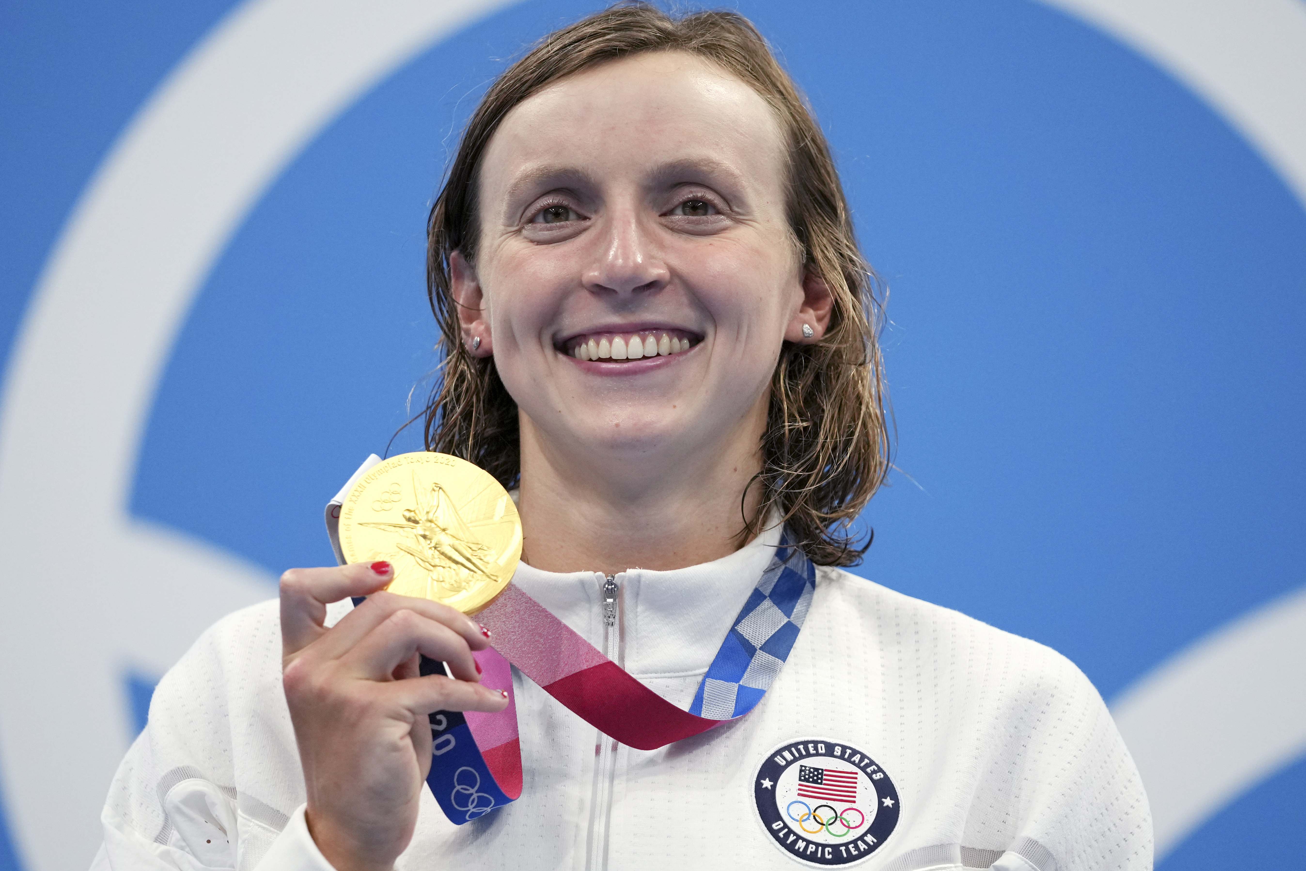 Katie Ledecky of the United States poses with her gold medal after winning the women's 1500-meters freestyle final at the 2020 Summer Olympics, Wednesday, July 28, 2021, in Tokyo, Japan.