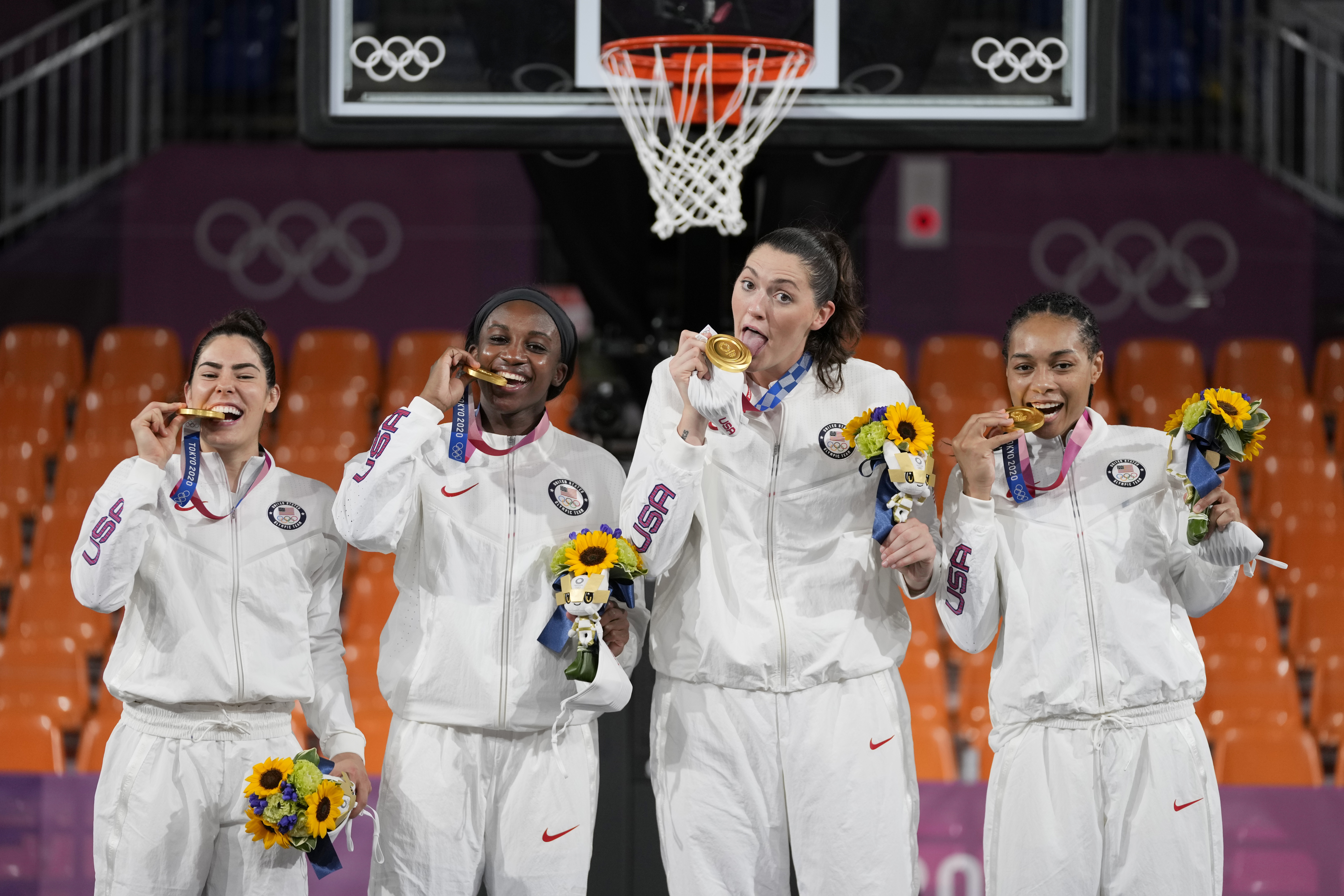 From left: Members of Team USA Kelsey Plum, Jacquelyn Young, Stefanie Dolson and Allisha Gray pose with their gold medals during the awards ceremony for women's 3-on-3 basketball at the 2020 Summer Olympics, Wednesday, July 28, 2021, in Tokyo, Japan. They became the first Olympians to win a gold medal in the women's 3x3 basketball category.