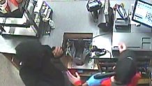 Surveillance photo of a suspect holding a gun to an Abington Wawa employee's head.