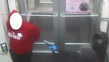 Surveillance photo of one of the suspects pointing a gun at an employee inside the Abington Wawa.
