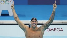 Caeleb Dressel celebrates a gold medal swim in the men's 100m freestyle at the Tokyo Olympics.