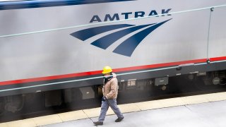 A worker is seen on the Amtrak train platform