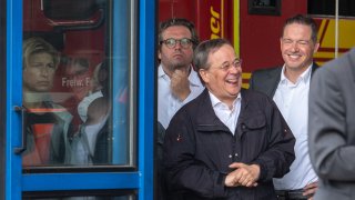 North Rhine-Westphalia's State Premier, Christian Democratic Union (CDU) leader and CDU's candidate for Chancellery Armin Laschet (C) laughs while the German President (unseen) delivers a speech after they visited the Rhein-Erft fire and rescue control center and in Erftstadt, western Germany, on July 17, 2021.