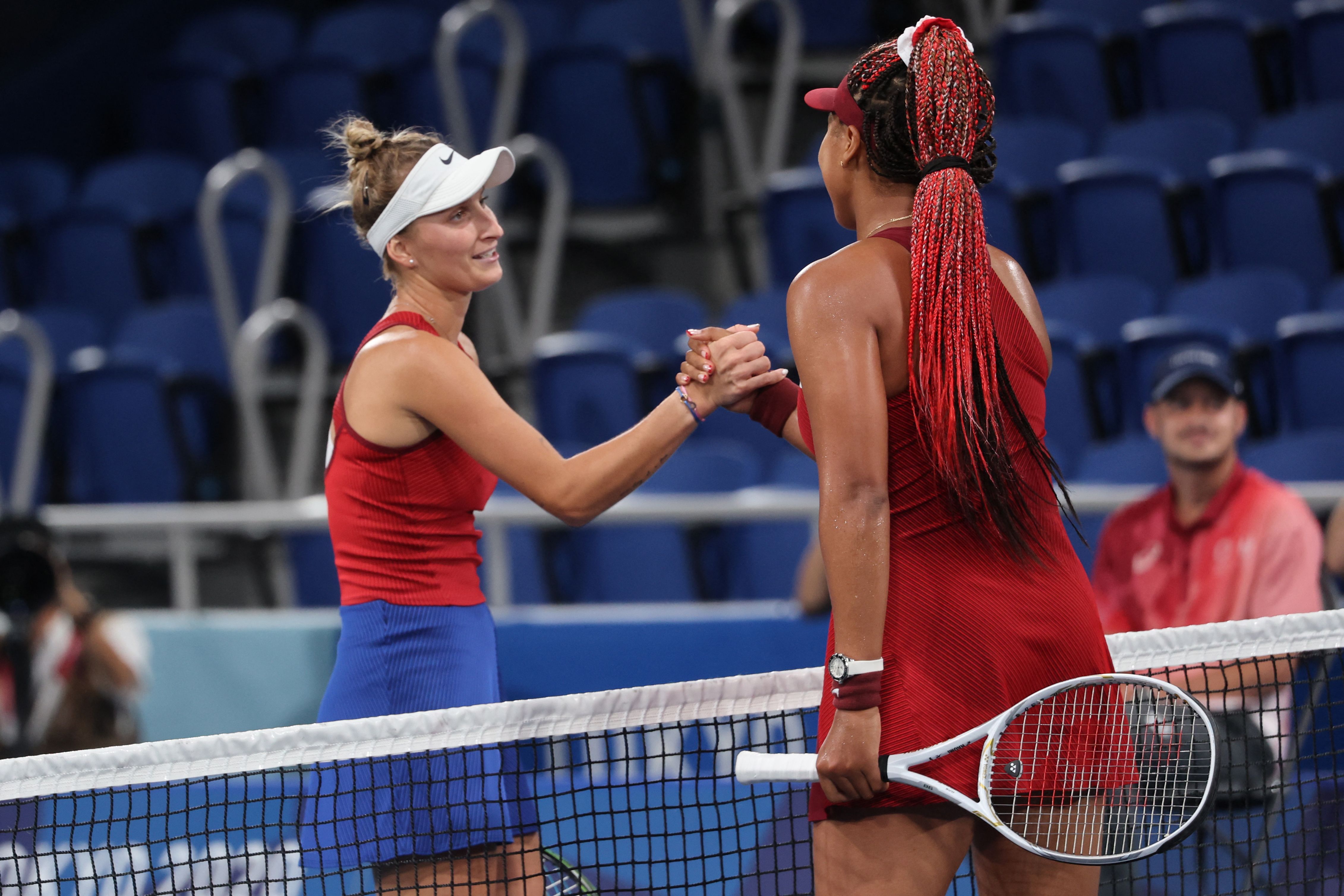 Czech Republic's Marketa Vondrousova (L) shakes hands with Japan's Naomi Osaka after winning their Tokyo 2020 Olympic Games women's singles third round tennis match at the Ariake Tennis Park in Tokyo on July 27, 2021.