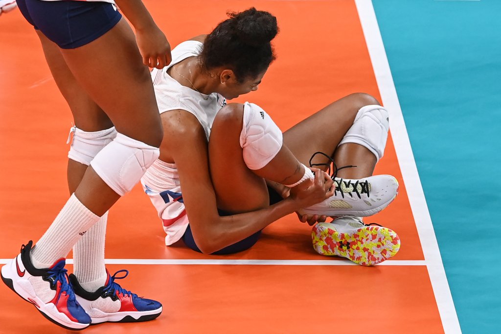 USA's Jordan Thompson reacts after getting injured in the women's preliminary round pool B volleyball match between USA and Russia during the Tokyo 2020 Olympic Games at Ariake Arena in Tokyo on July 31, 2021.