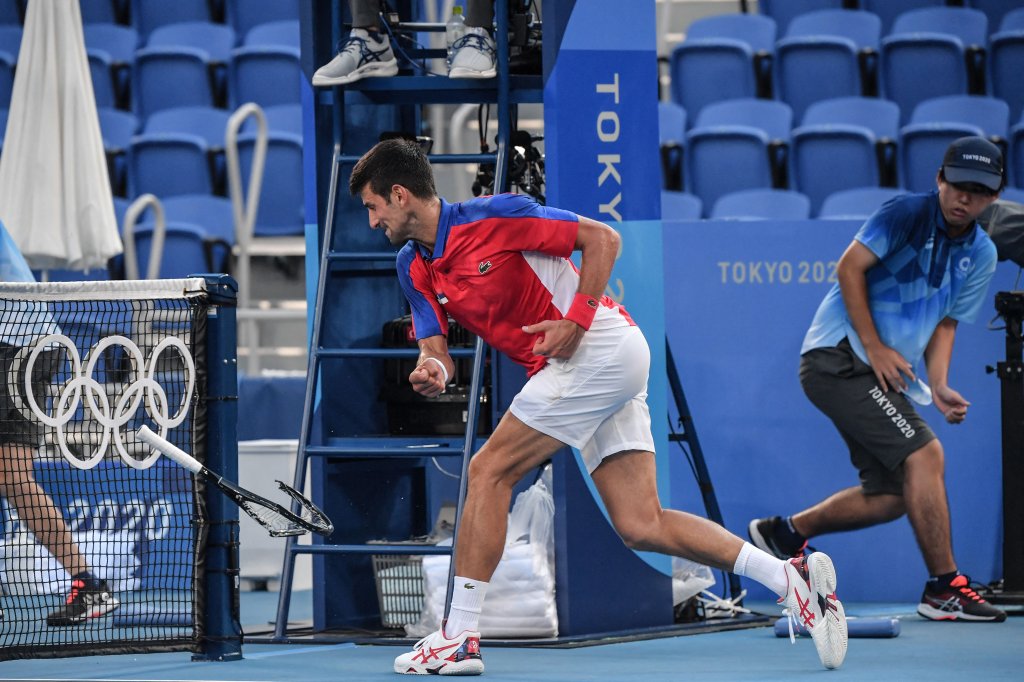 Serbia's Novak Djokovic smashes his racket during his Tokyo 2020 Olympic Games men's singles tennis match for the bronze medal against Spain's Pablo Carreno Busta at the Ariake Tennis Park in Tokyo on July 31, 2021.