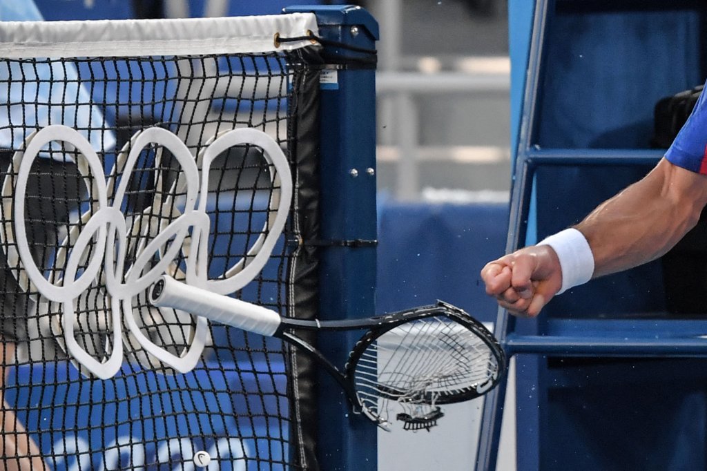 Serbia's Novak Djokovic smashes his racket during his Tokyo 2020 Olympic Games men's singles tennis match for the bronze medal against Spain's Pablo Carreno Busta at the Ariake Tennis Park in Tokyo on July 31, 2021.