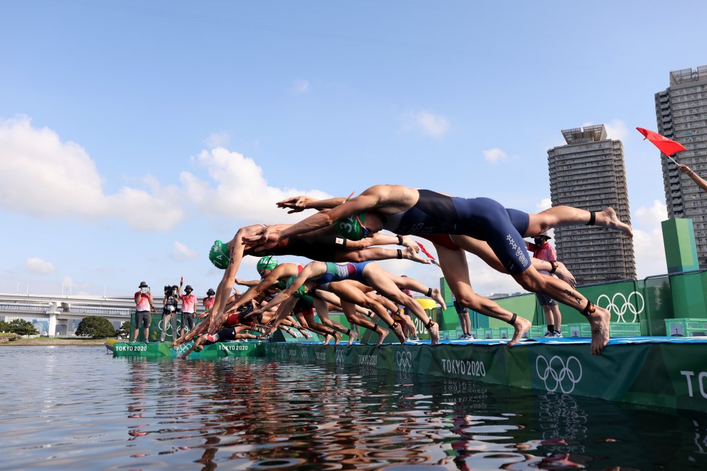 Summer Rappaport of Team United States and other competitors dive during the Mixed Relay Triathlon on day eight of the Tokyo 2020 Olympic Games at Odaiba Marine Park on July 31, 2021 in Tokyo, Japan.