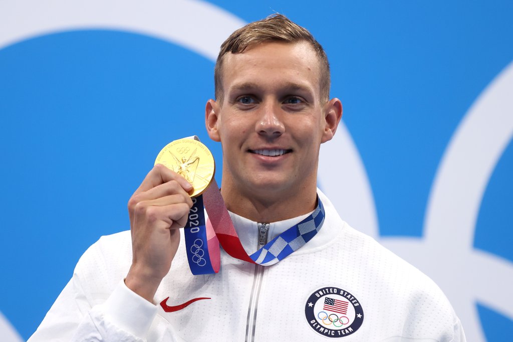 Gold medalist Caeleb Dressel of Team United States poses with the gold medal for the Men's 100m Butterfly Final at Tokyo Aquatics Centre on July 31, 2021 in Tokyo, Japan.