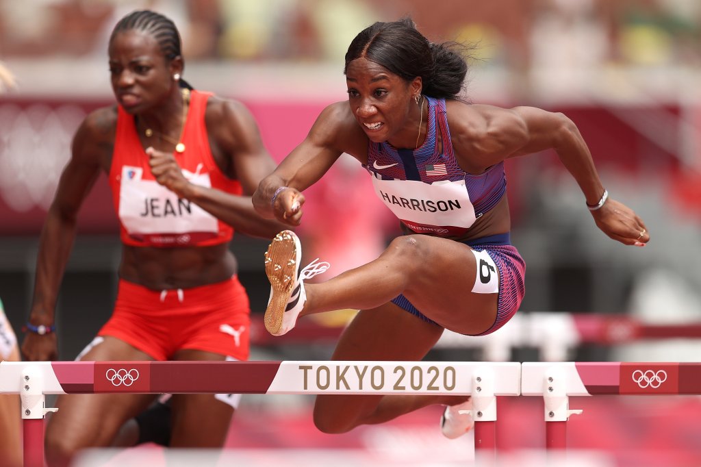 Mulern Jean of Team Haiti and Kendra Harrison of Team United States compete in round one of the women's 100m hurdles heats on day eight of the Tokyo 2020 Olympic Games at Olympic Stadium on July 31, 2021, in Tokyo, Japan.
