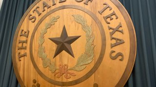 A wooden The State of Texas seal appears in the Texas Capitol in Austin.
