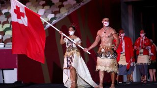 TOKYO, JAPAN - JULY 23: Flag bearers Malia Paseka and Pita Taufatofua of Team Tonga lead their team out during the Opening Ceremony of the Tokyo 2020 Olympic Games at Olympic Stadium on July 23, 2021 in Tokyo, Japan.