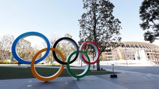 The Olympic rings appear next to Tokyo National Stadium