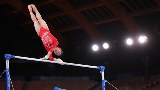 China's Xijing Tang competes on uneven bars during women's qualification