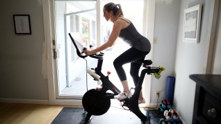 Jen Van Santvoord rides her Peloton exercise bike at her home on April 07, 2020 in San Anselmo, California.