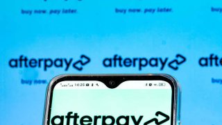 An Afterpay logo is seen displayed on a smartphone.