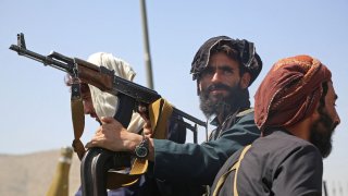 Taliban fighters stand guard in a vehicle along the roadside in Kabul on August 16, 2021, after a stunningly swift end to Afghanistan’s 20-year war, as thousands of people mobbed the city’s airport trying to flee the group’s feared hardline brand of Islamist rule.
