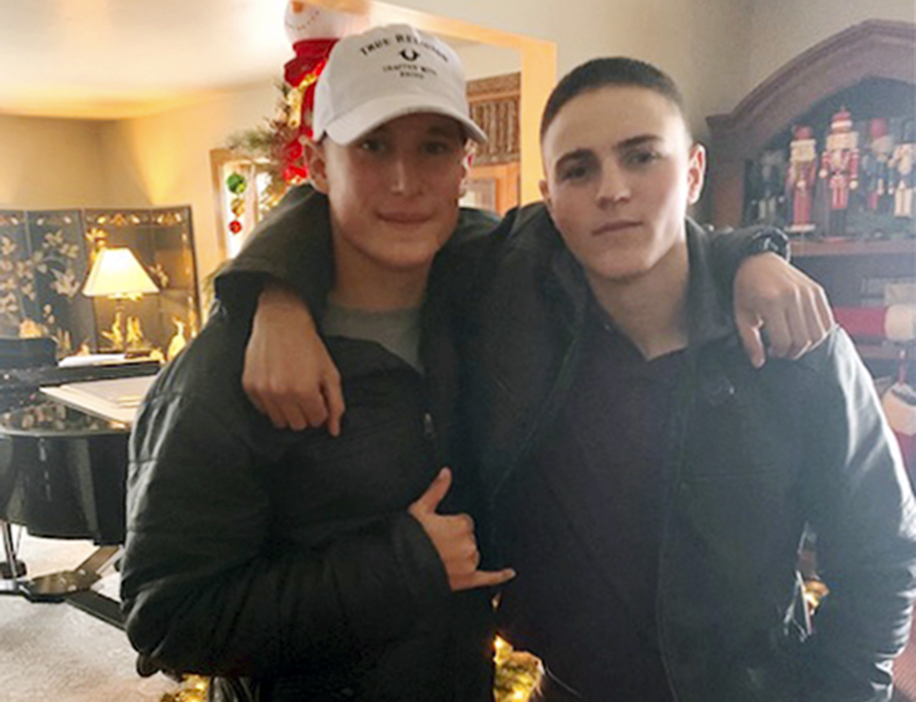 This Dec. 2019, photo provided by Regi Stone shows Eli Stone, left, and Rylee McCollum, at Christmas in Stone's house in Jackson, Wyo. Rylee McCollum, of Bondurant, Wyo., was one of the U.S. Marines killed in the suicide bombing at the Kabul airport, in Afghanistan, according to his sister, Roice McCollum. 