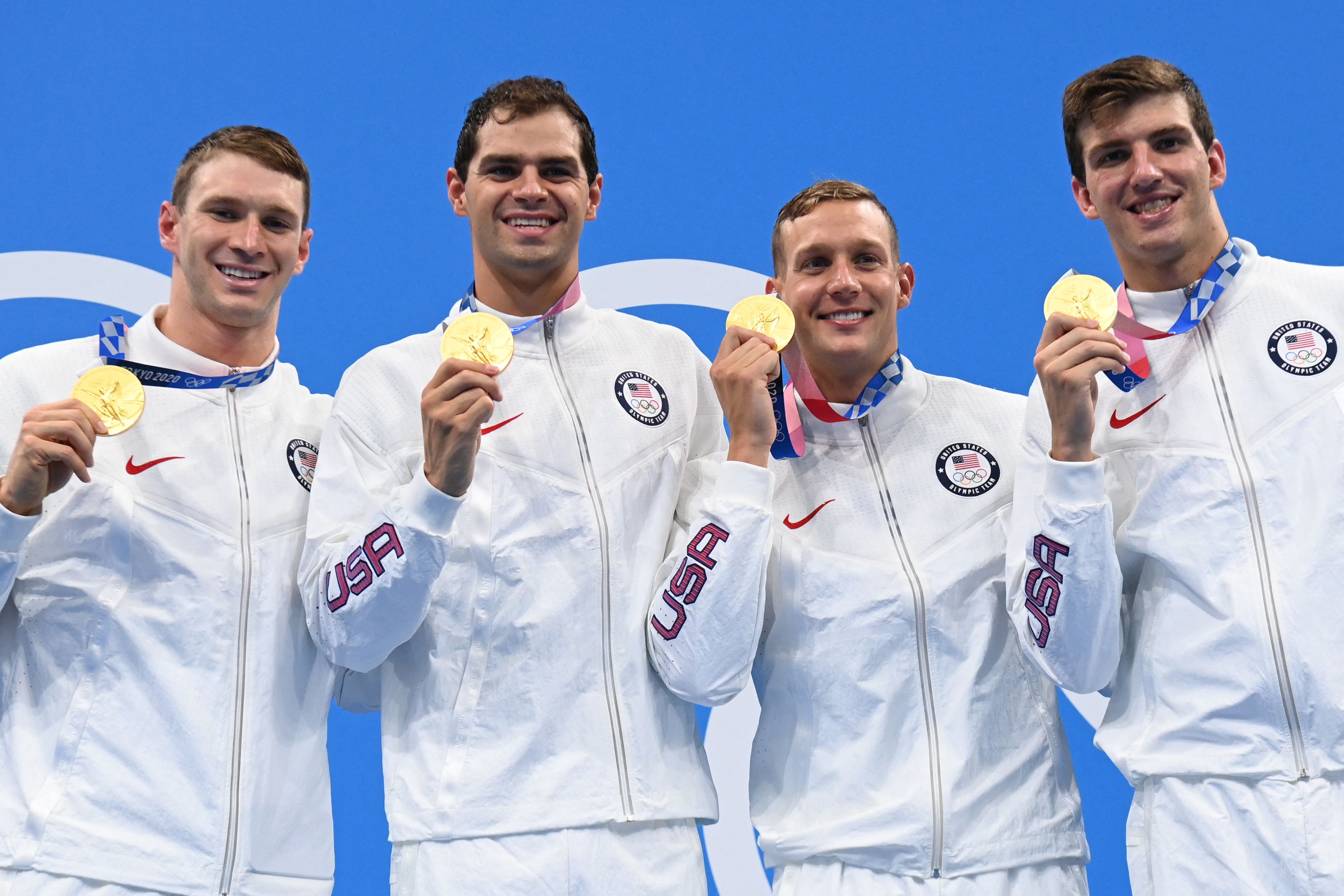 Gold medallists (from L) USA's Ryan Murphy, USA's Michael Andrew, USA's Caeleb Dressel and USA's Zach Apple pose on the podium after the final of the men's 4x100m medley relay swimming event during the Tokyo 2020 Olympic Games at the Tokyo Aquatics Centre in Tokyo on August 1, 2021.