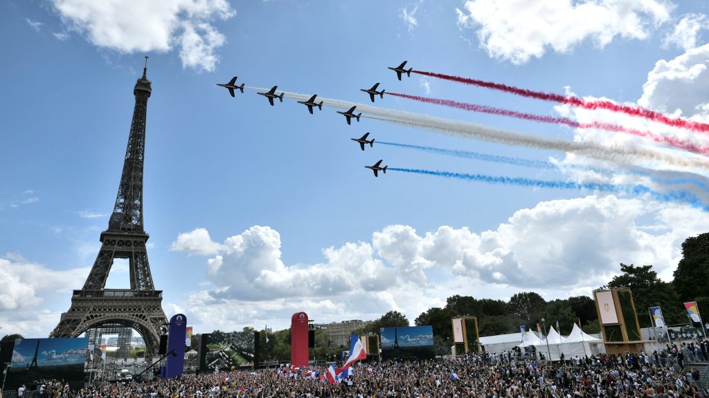 French aerial patrol fly over the fan village of The Trocadero set in front of The Eiffel Tower, in Paris on Aug. 8, 2021 upon the transmission of the closing ceremony of the Tokyo 2020 Olympic Games.