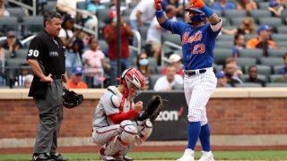 Javier Baez gives thumbs down after crossing homeplate