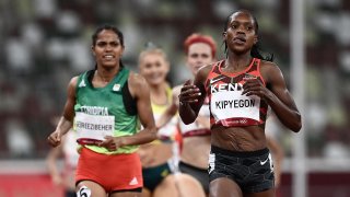 Kenya's Faith Kipyegon (R) wins ahead of Ethiopia's Freweyni Gebreezibeher (L) in the women's 1500m semi-finals during the Tokyo 2020 Olympic Games