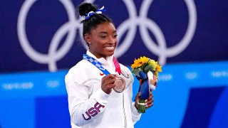 Simone Biles poses with bronze medal