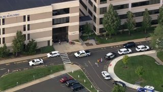 Police vehicles outside a hospital after Chief Joseph Kelly III Yardley was shot in 2021.